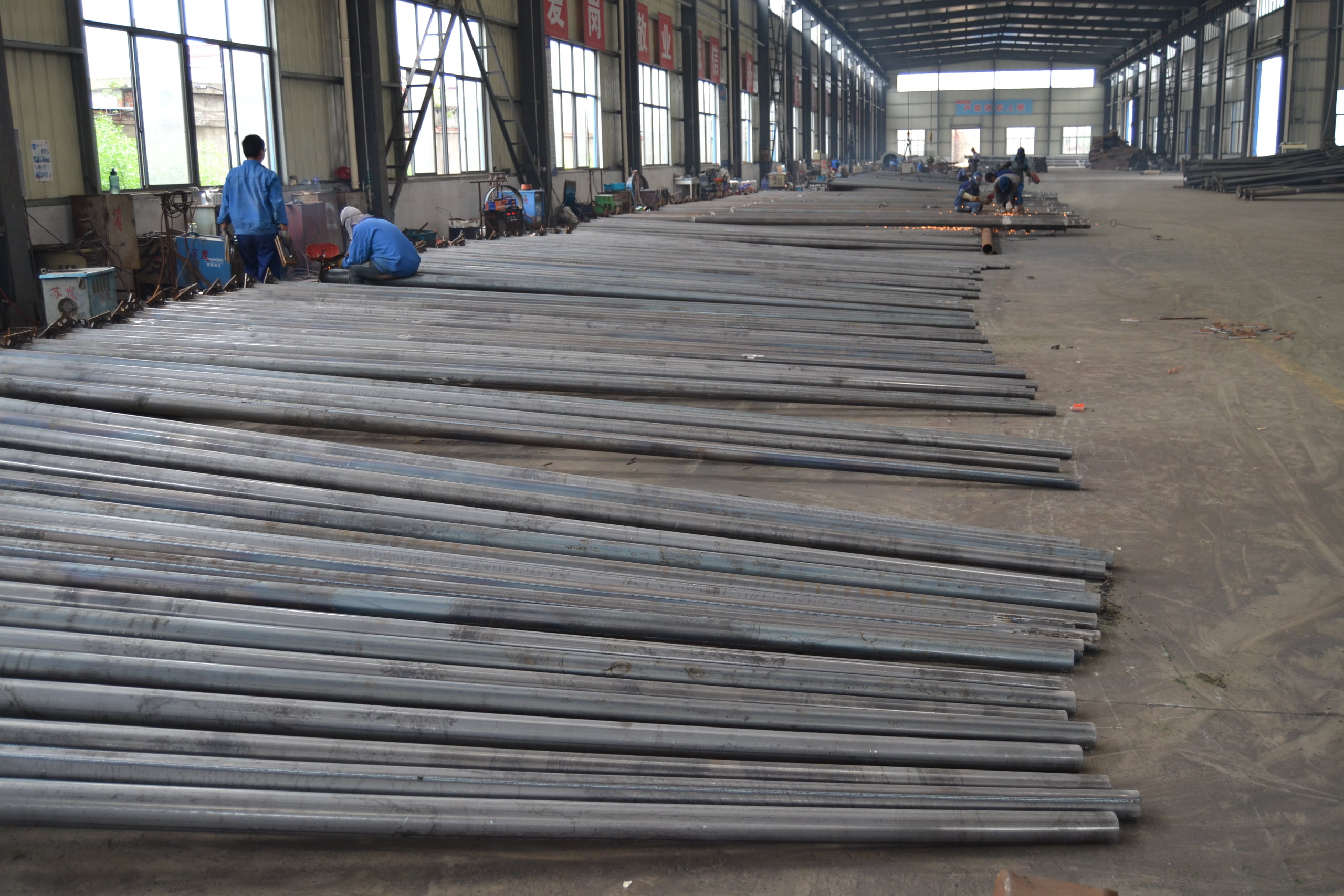 An aerial view of a massive, modern factory complex at sunset